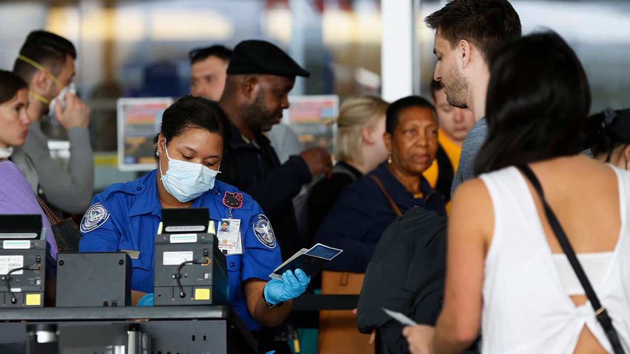 Photo of people at a checkpoint at a checkpoint inside an airline terminal at John F. Kennedy Airport in New York