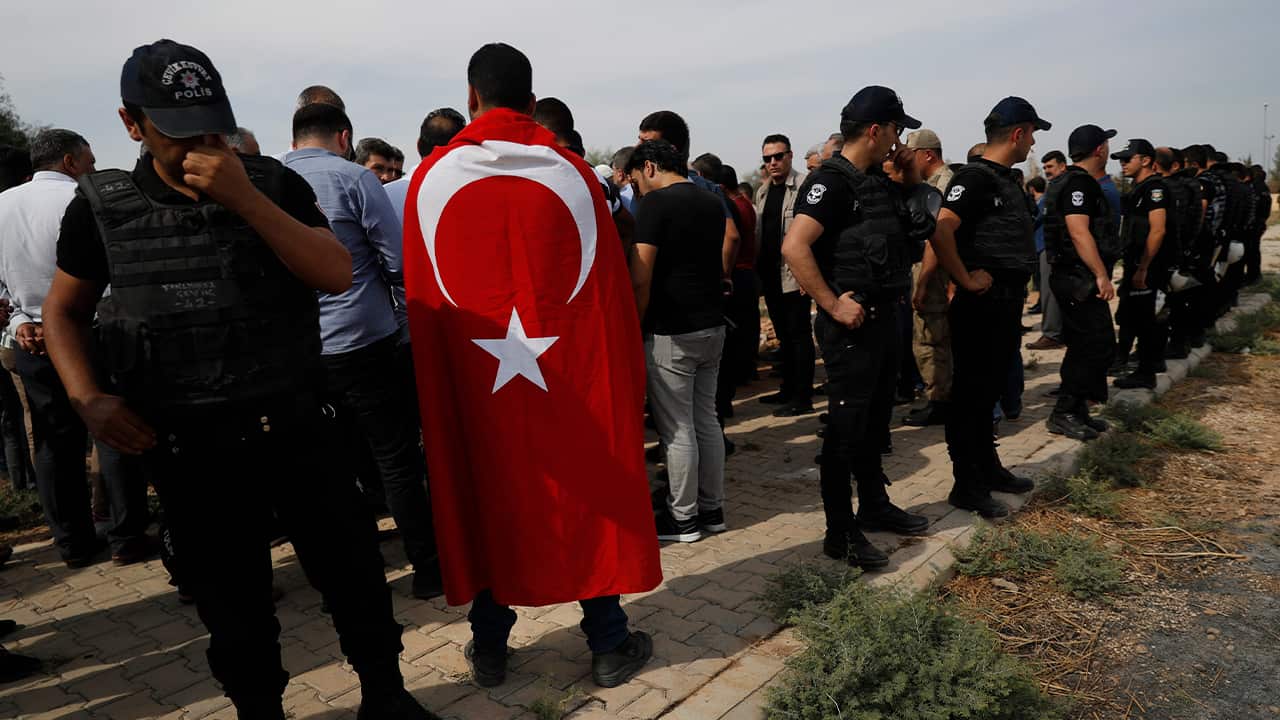 Photo of Turkish police officers securing the area 