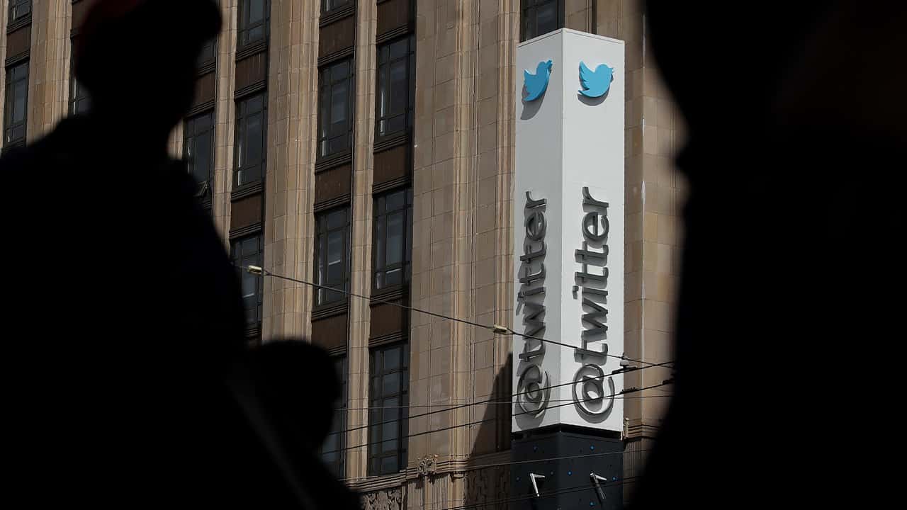 Photo of pedestrians walking across from the Twitter office building