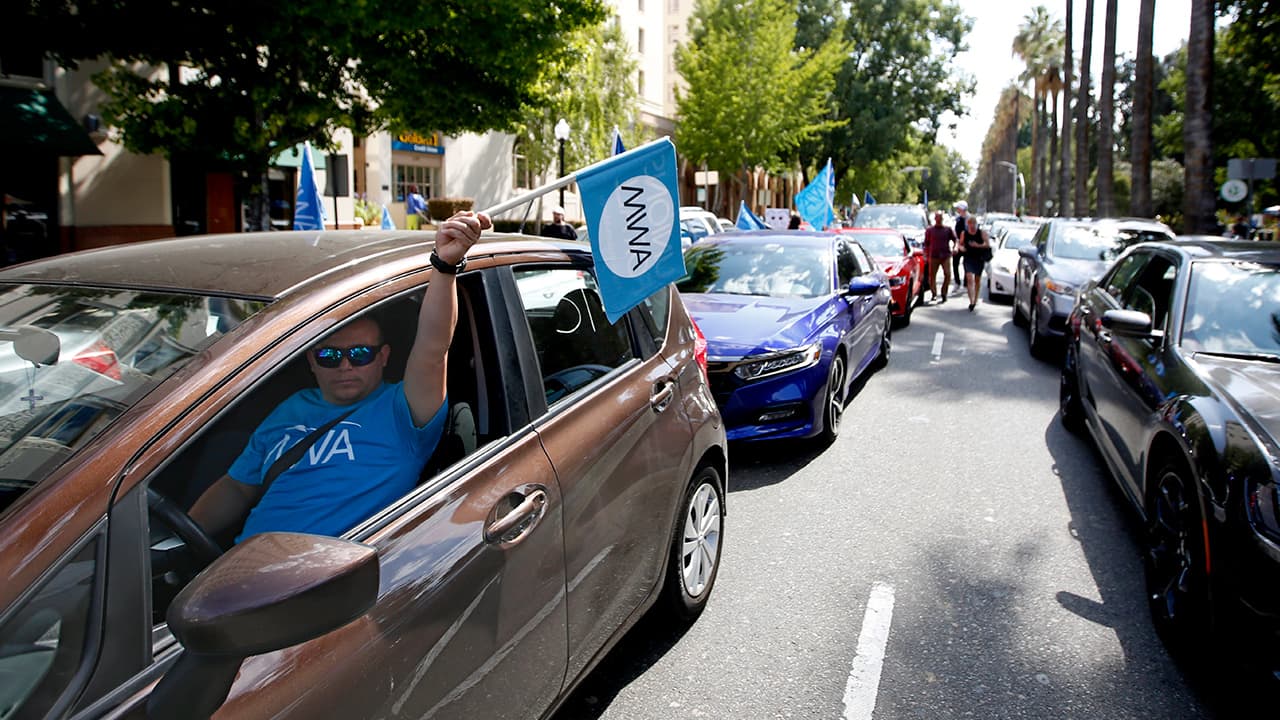 Photo of supporters of a measure to limit when companies can label workers as independent contractors