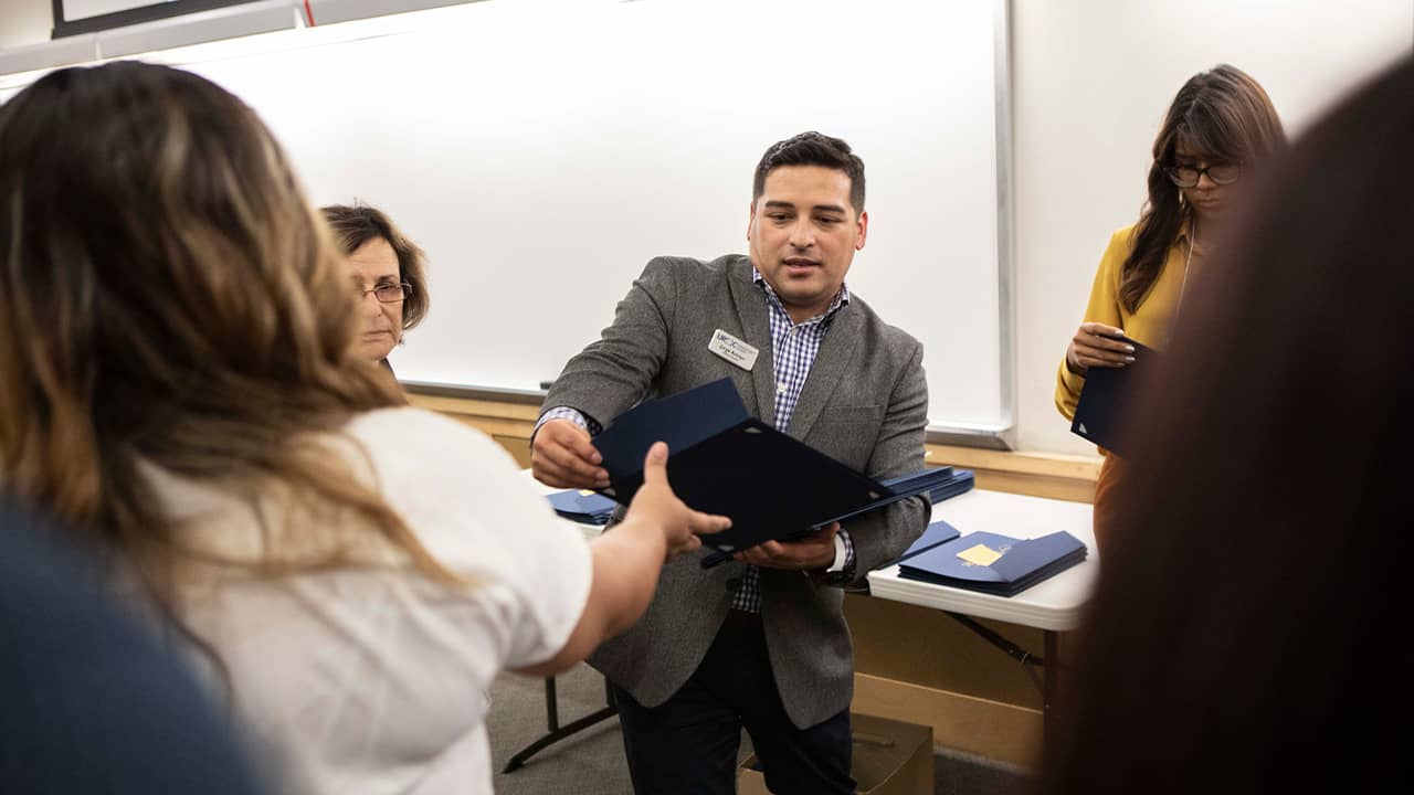 Photo of Jorge Arroyo handing out certificates 