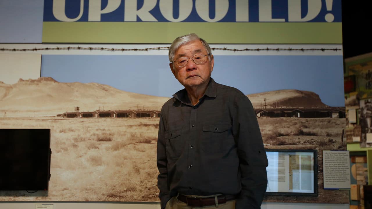 Photo of Les Ouchida at the permanent exhibit titled "UpRooted Japanese Americans in World War II" at the California Museum in Sacramento
