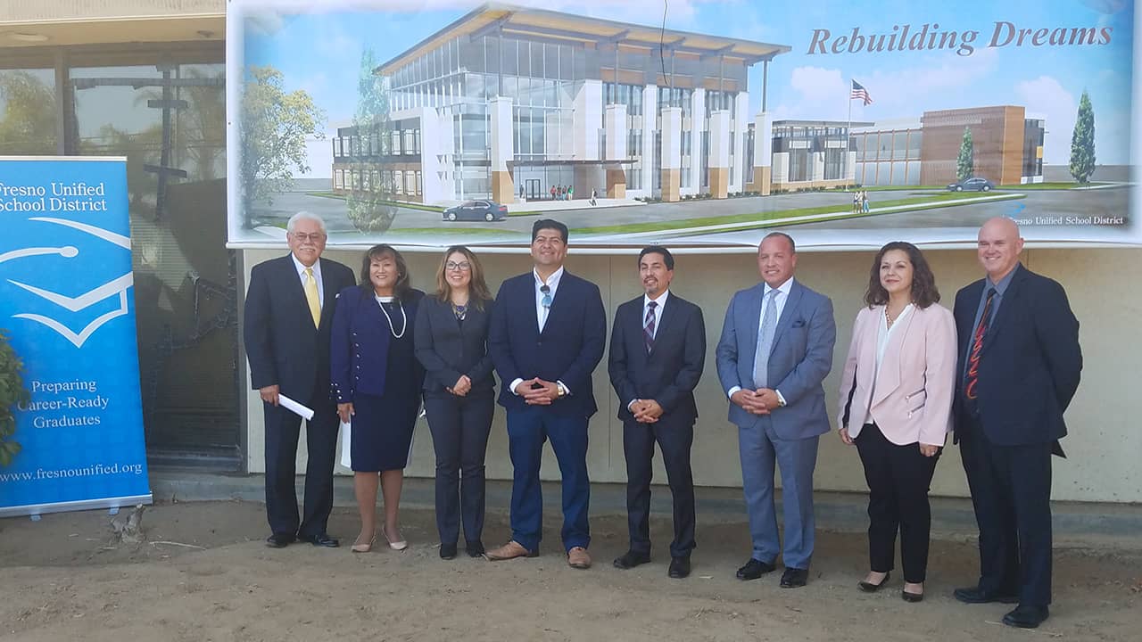 Photo of Fresno area politicians in front of architect's rendering of the "Urban Academy"