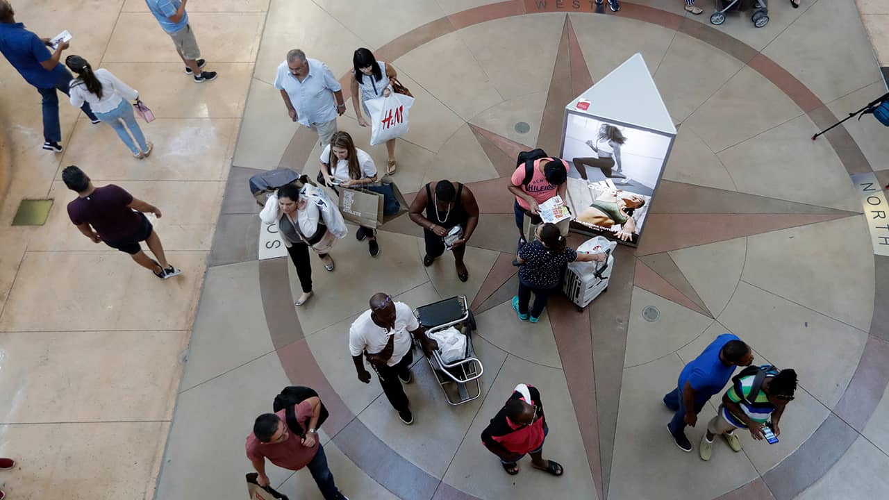 Photo of shoppers walking through a mall