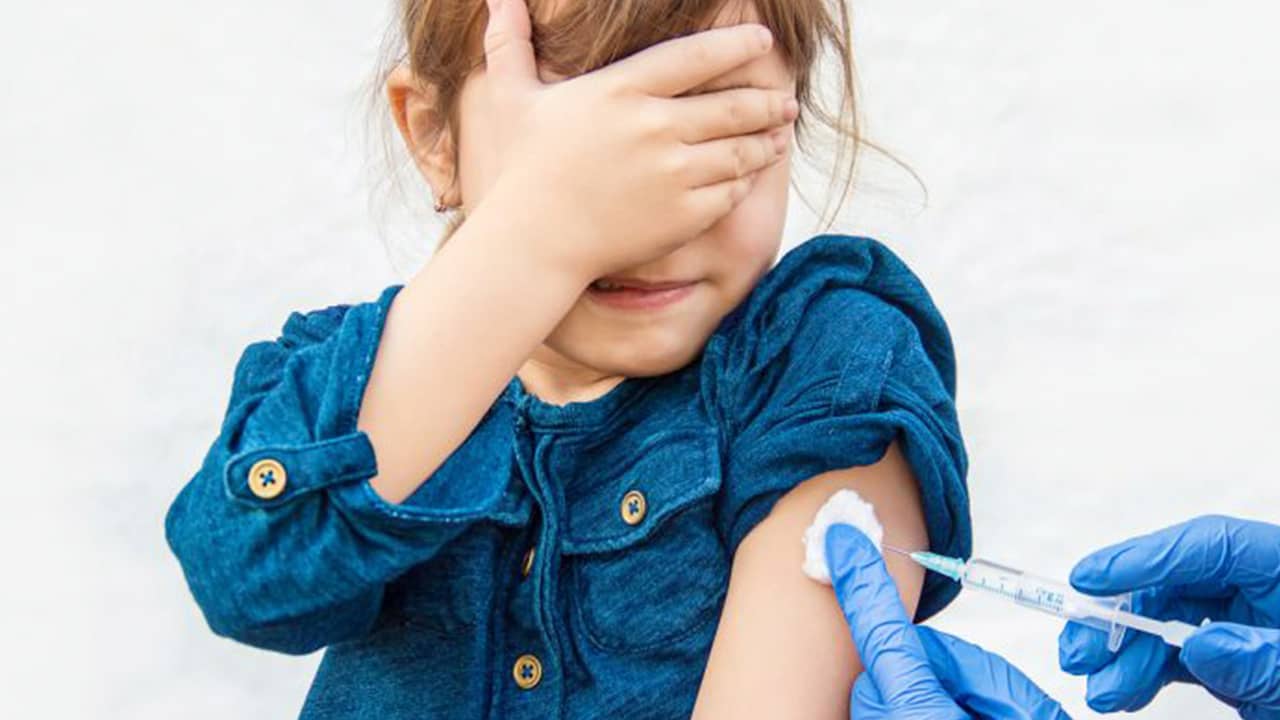 Photo of a young girl getting vaccinated