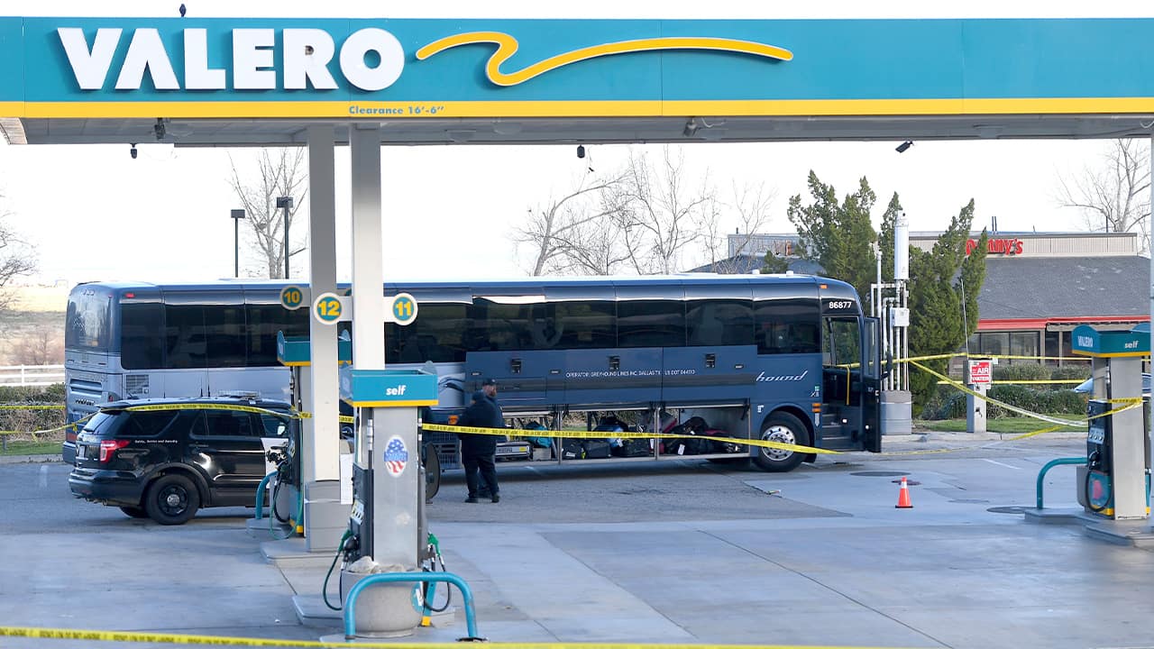 Photo of investigators outside of a Greyhound bus