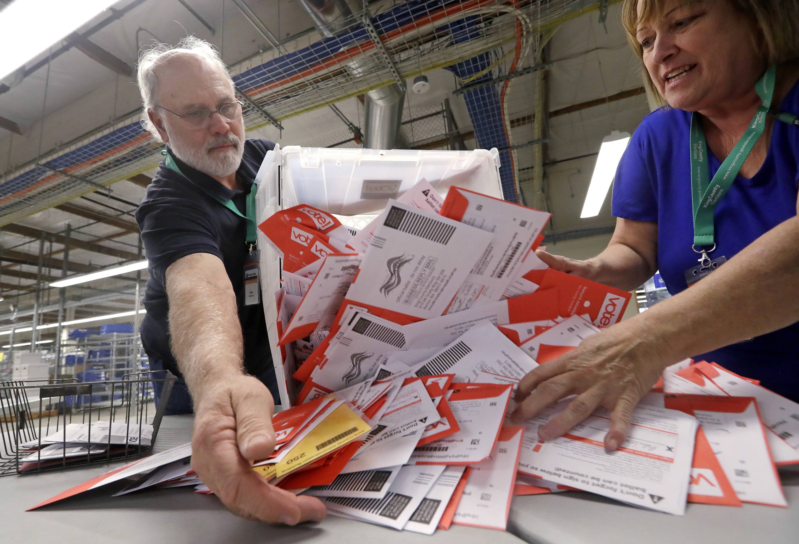 Photo of election workers dumping ballots collected from drop boxes