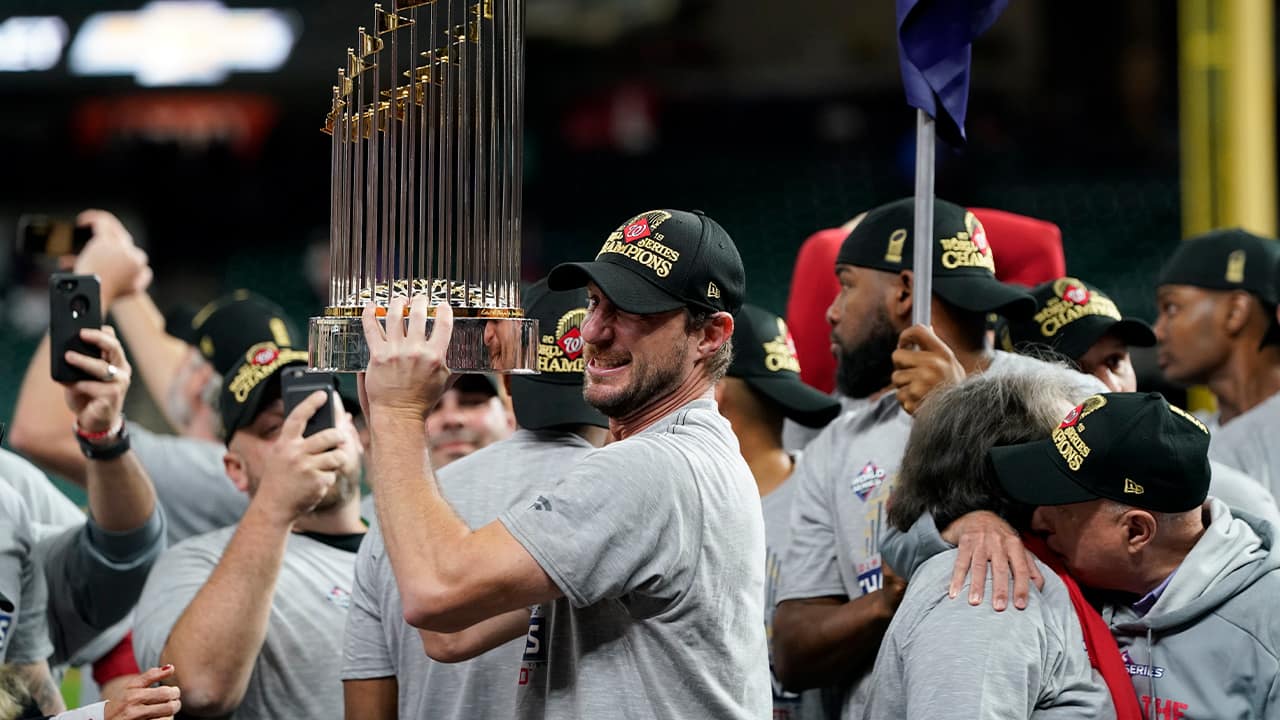 Photo of Washington Nationals starting pitcher Max Scherzer with the trophy after Game 7 of the baseball World Series against the Houston Astros in Houston