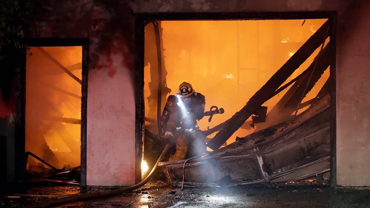 Photo of firefighter in a ravaged home 