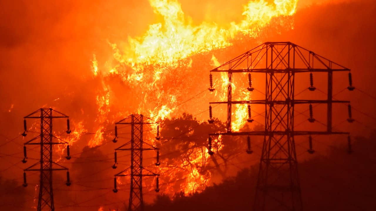 Photo of flames burning near power lines in Sycamore Canyon