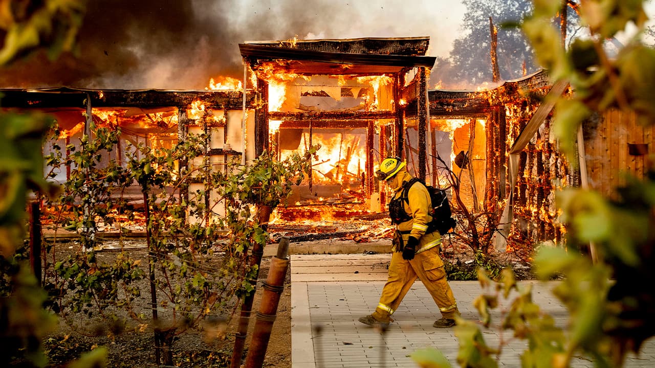 Photo of Woodbridge firefighter Joe Zurilgen passing a burning home