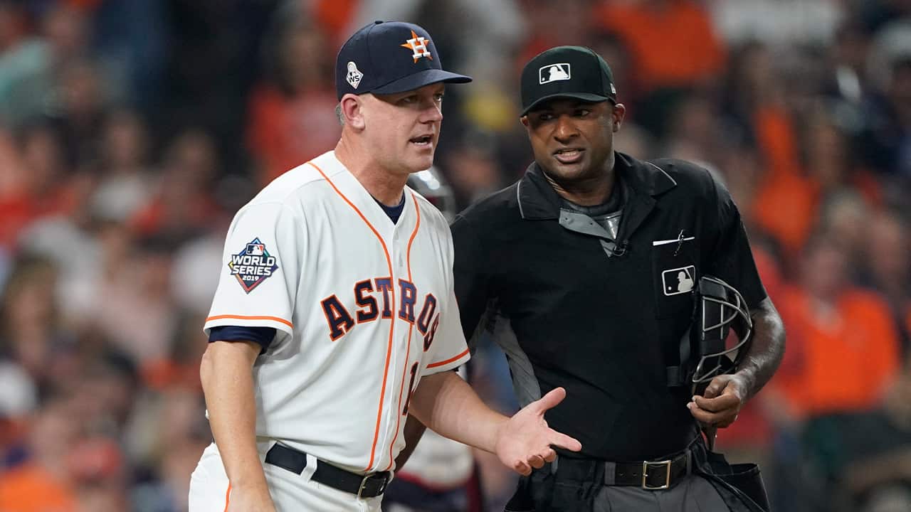 Photo of AJ Hinch arguing a call with an umpire