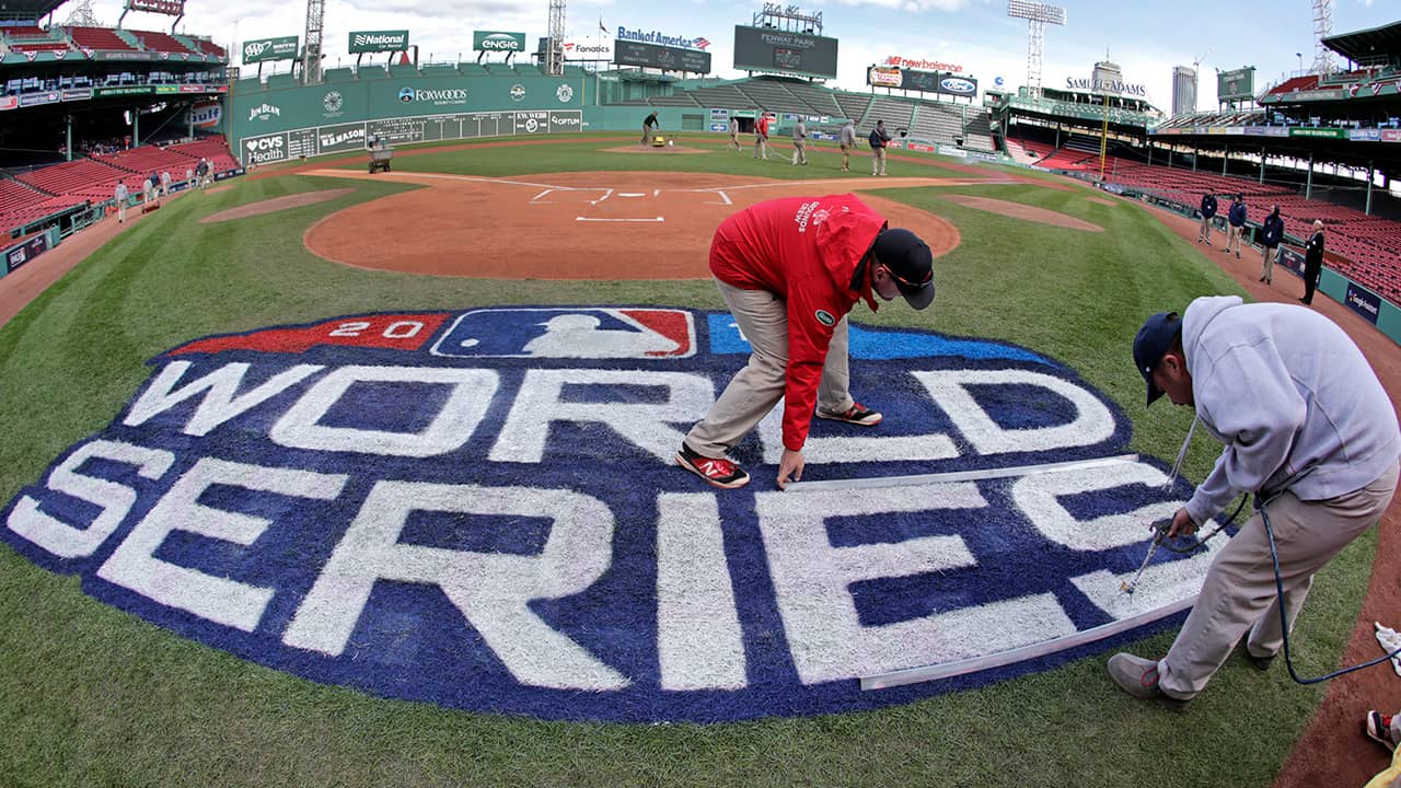 Photo of crew members painting the World Series logo at Fenway Park