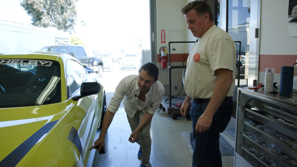 Chip Foose examines the work on a current Mustang project