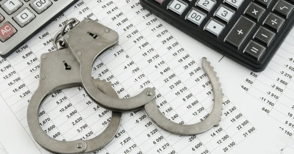 Image of handcuffs, expense lists, and calculators symbolizing fraud