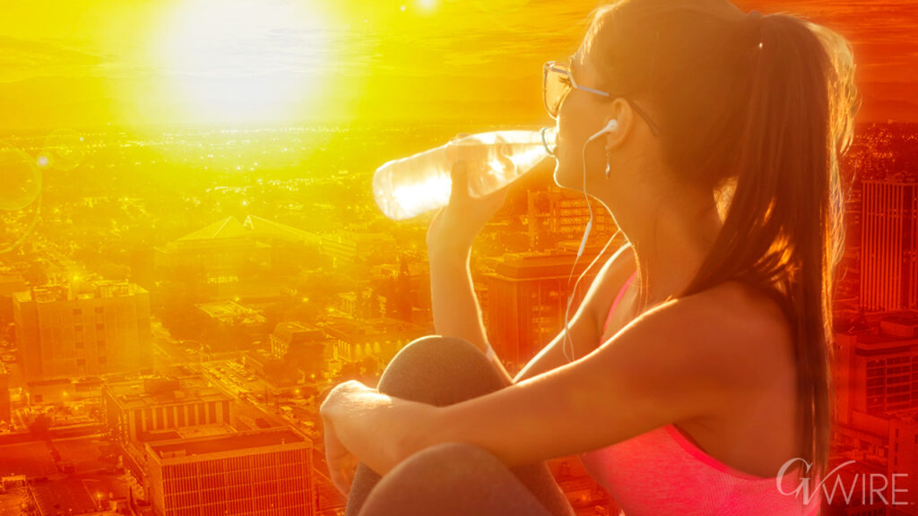 Composite image of a young woman drinking water under a blazing sun, symbolizing a Central California heatwave