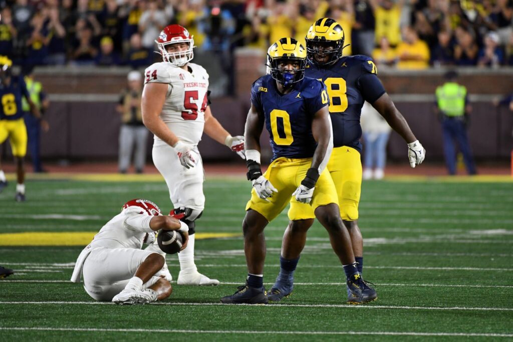 Michigan defensive end Josaiah Stewart (0) celebrates after sacking Fresno State quarterback Mikey Keene, bottom, in the second half of an NCAA college football game, Saturday, Aug. 31, 2024, in Ann Arbor, Mich. (AP Photo/Jose Juarez)
