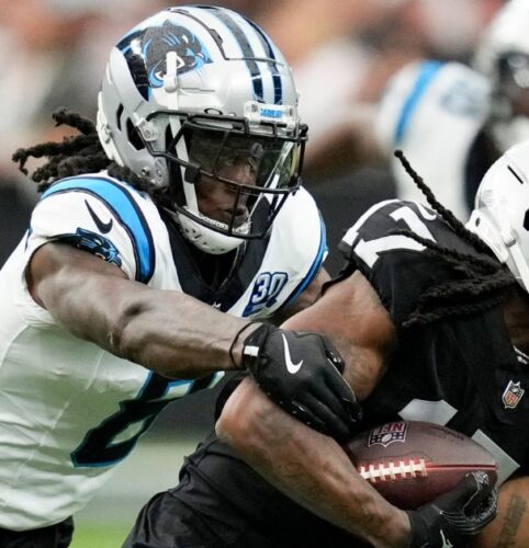 Las Vegas Raiders wide receiver Davante Adams is tackled by Carolina Panthers cornerback Jaycee Horn during the first half of an NFL football game, Sunday, Sept. 22, 2024, in Las Vegas. (AP PhotoJ