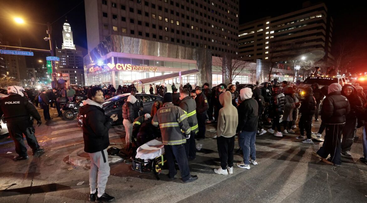 Police and emergency personnel assist multiple people who were struck by a car, at Broad and Spring Garden Street, while celebrating after the Eagles won the Washington Commanders vs. Philadelphia Eagles NFC Championship game in Philadelphia on Sunday, Jan. 26, 2025. (Elizabeth Robertson/The Philadelphia Inquirer via AP)