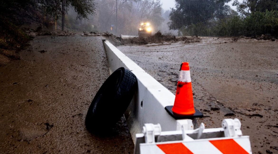 A road is covered in mud in the Eaton Fire zone during a storm Thursday, Feb. 13, 2025, in Altadena, Calif. (AP Photo/Etienne Laurent)