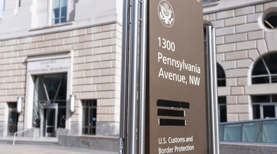 A street sign with names of U.S. government agencies housed at the Ronald Regan Building, including the United States Agency for International Development, or USAID headquarters in Washington, is pictured with one building occupant taped, Friday, Feb. 7, 2025, in Washington. (AP/Manuel Balce Ceneta)