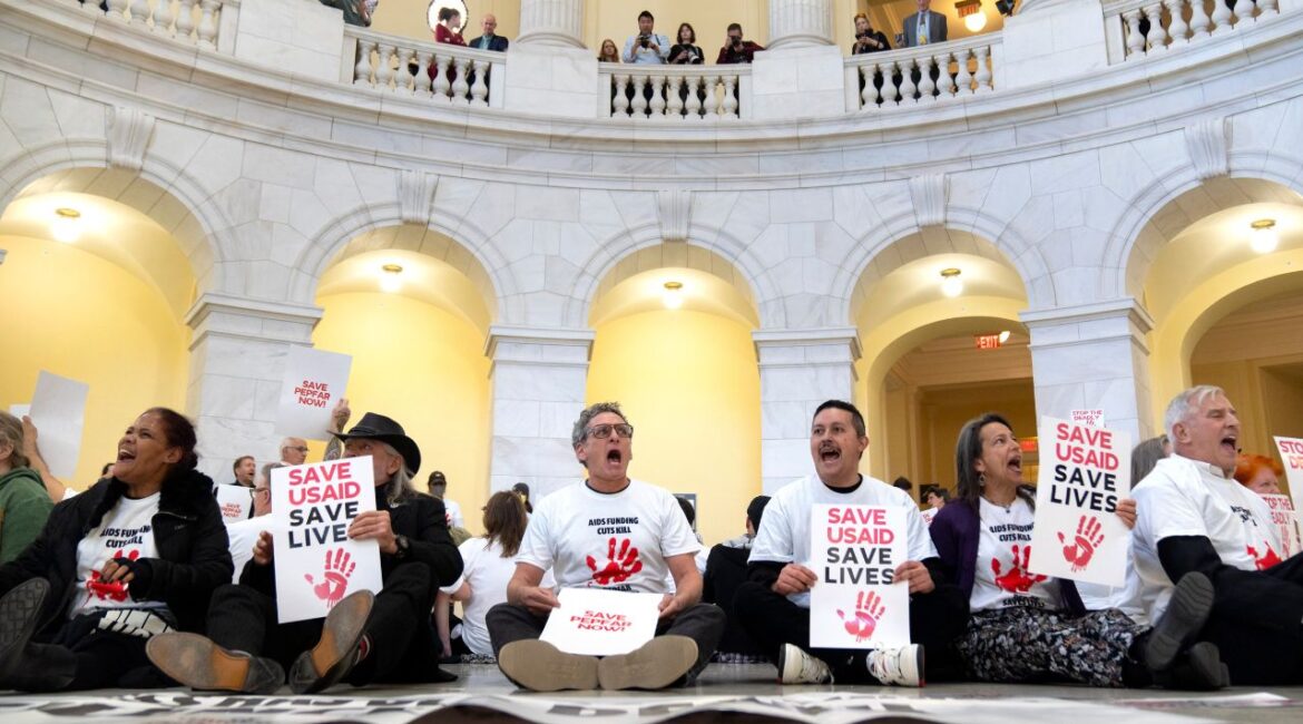 Demonstrators protest against cuts to American foreign aid spending, including USAID and the PEPFAR program to combat HIV/AIDS, at the Cannon House Office Building on Capitol Hill, Wednesday, Feb. 26, 2025, in Washington. (AP Photo/Mark Schiefelbein)