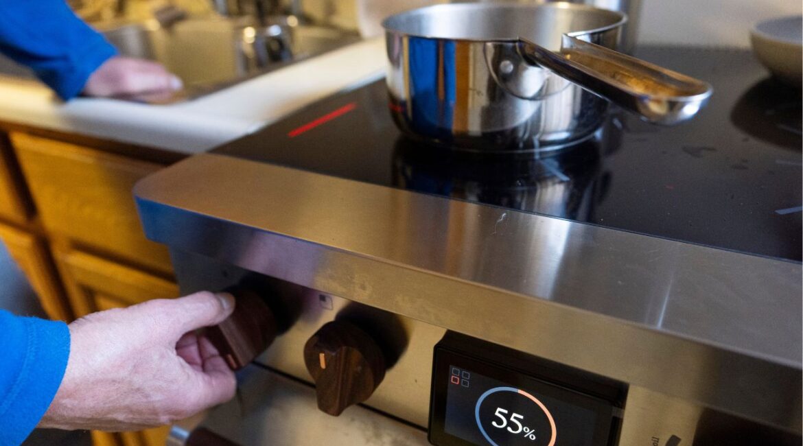 Ed Yaker boils water on a Copper stove, an electric induction stove, on Feb. 10, 2025, in New York. (AP/John Minchillo)