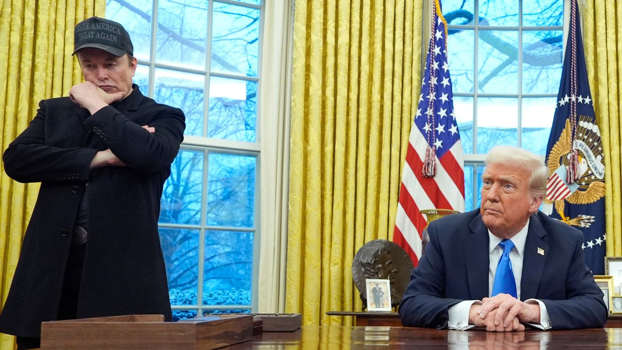 Elon Musk listens as President Donald Trump speaks with reporters in the Oval Office at the White House, Tuesday, Feb. 11, 2025, in Washington. (AP/Alex Brandon)