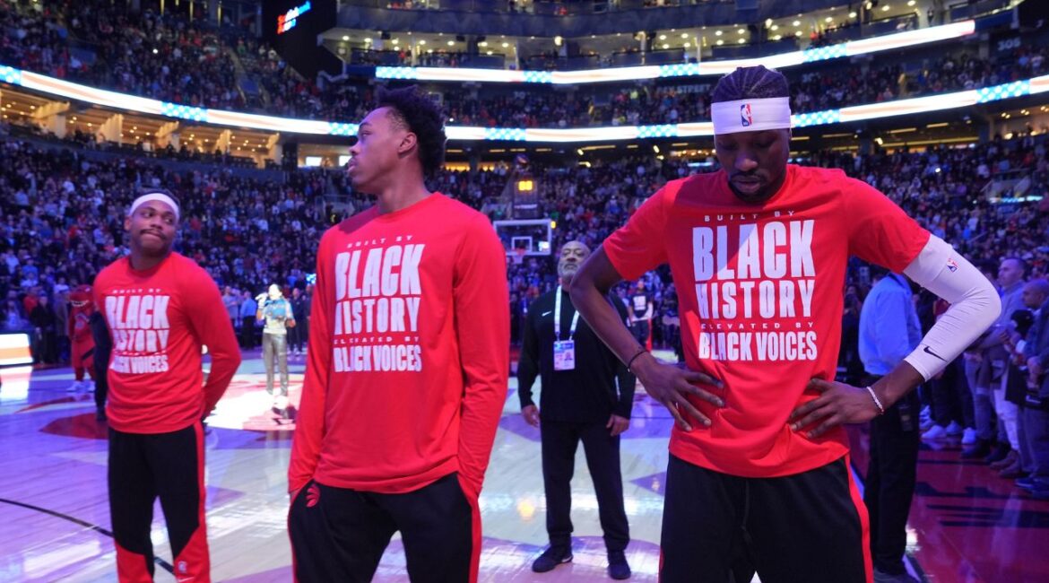 From left to right, Toronto Raptors forwards Bruce Brown, Scottie Barnes and Chris Boucher react as fans boo the United States national anthem before NBA basketball game action against the Los Angeles Clippers in Toronto, Sunday, Feb. 2, 2025. (Frank Gunn/The Canadian Press via AP)