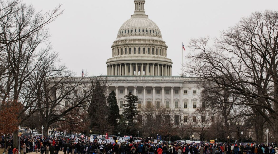 Members of the American Federation of Government Employees (AFGE) union gather in the Upper Senate Park next to the US Capitol building to protest cuts by Elon Musk and the Department of Government Efficiency (DOGE) in Washington, Feb. 11, 2025. Rather than boycott President Donald Trump’s address to a joint session of Congress, some Democratic lawmakers are inviting former federal workers to the speech on Tuesday as a way to protest the mass firings and funding cuts that have defined President Trump’s first month back in office. (Samuel Corum/The New York Times)