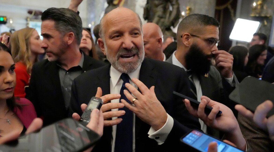 Secretary of Commerce Howard Lutnick speaks with reporters after President Donald Trump addressed a joint session of Congress at the Capitol in Washington, Tuesday, March 4, 2025. (AP Photo/Ben Curtis)