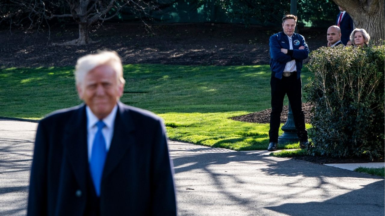 Elon Musk watches with White House staff including Walt Nauta and Susie Wiles as President Donald Trump approached reporters before departing Washington for the weekend, on March 21, 2025. Musk has repeatedly gone out of his way to disagree with Trump on tariffs policy, suggesting he believes he is not subject to the same rules that govern others in the president’s inner circle. (Haiyun Jiang/The New York Times)
