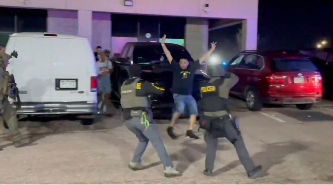 In this image taken from video released by the U.S. Drug Enforcement Administration, officers stop a patron from a nightclub where a raid occurred Sunday, April 27, 2025, in Colorado Springs, Colo. (U.S. Drug Enforcement Administration via AP)