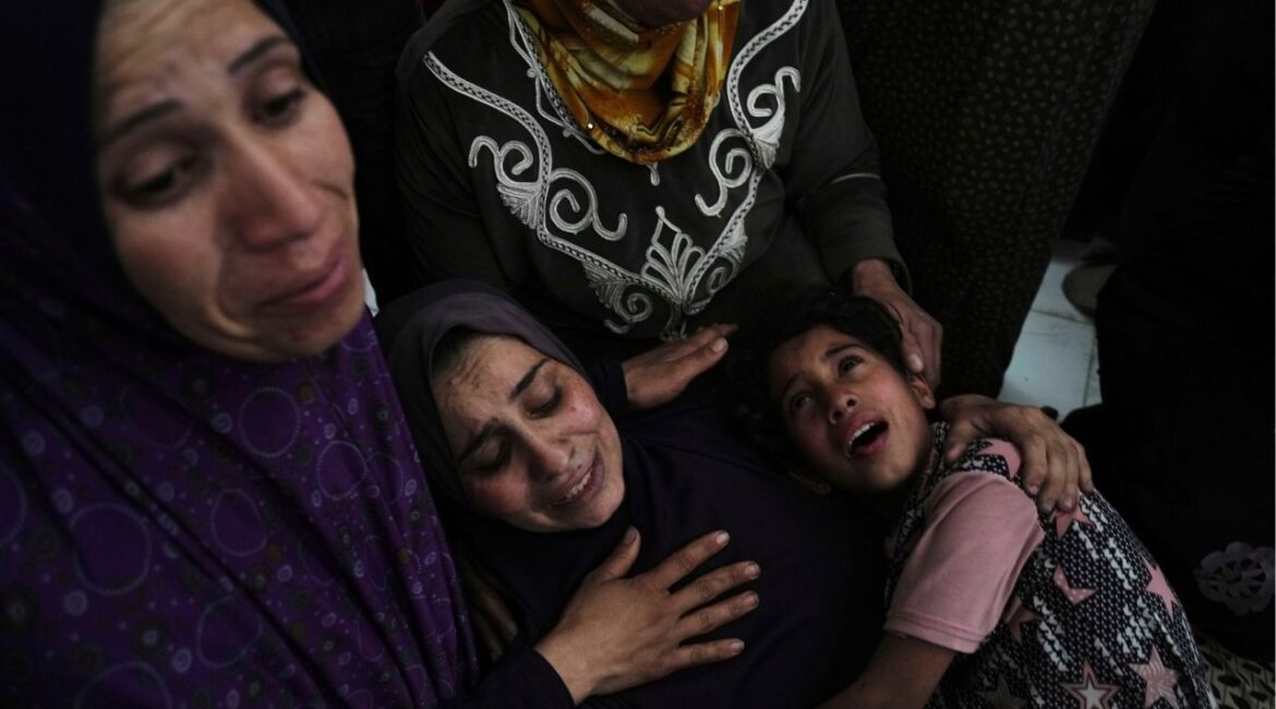 Palestinians grieve over the bodies of their relatives, who were killed in an Israeli airstrike, as they prepare for burial at a hospital in Beit Lahiya, Gaza Strip, on Wednesday, April 2, 2025. (AP/Jehad Alshrafi)