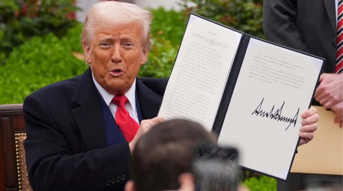 President Donald Trump holds a signed executive order during an event to announce new tariffs in the Rose Garden of the White House, Wednesday, April 2, 2025, in Washington. (AP/Evan Vucci)
