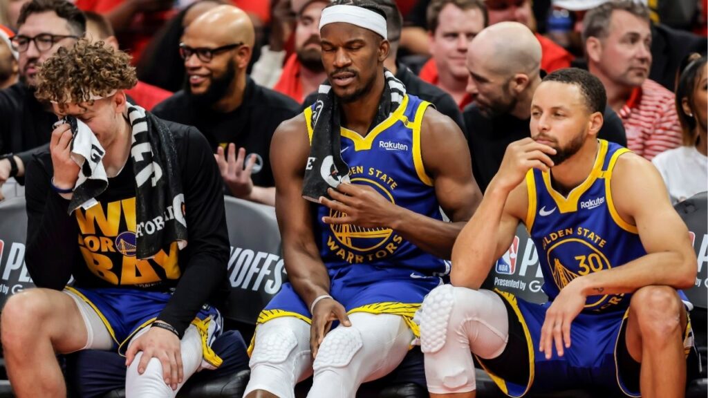 Brandin Podziemksi (2), Jimmy Butler (10) and Stephen Curry (30) react on the bench in the final seconds of the second half as the Golden State Warriors played the Houston Rockets in Game 5 of the First Round of the NBA Playoffs at Toyota Center in Houston, Texas on Wednesday, April 30, 2025. (Carlos Avila Gonzalez/San Francisco Chronicle via AP)