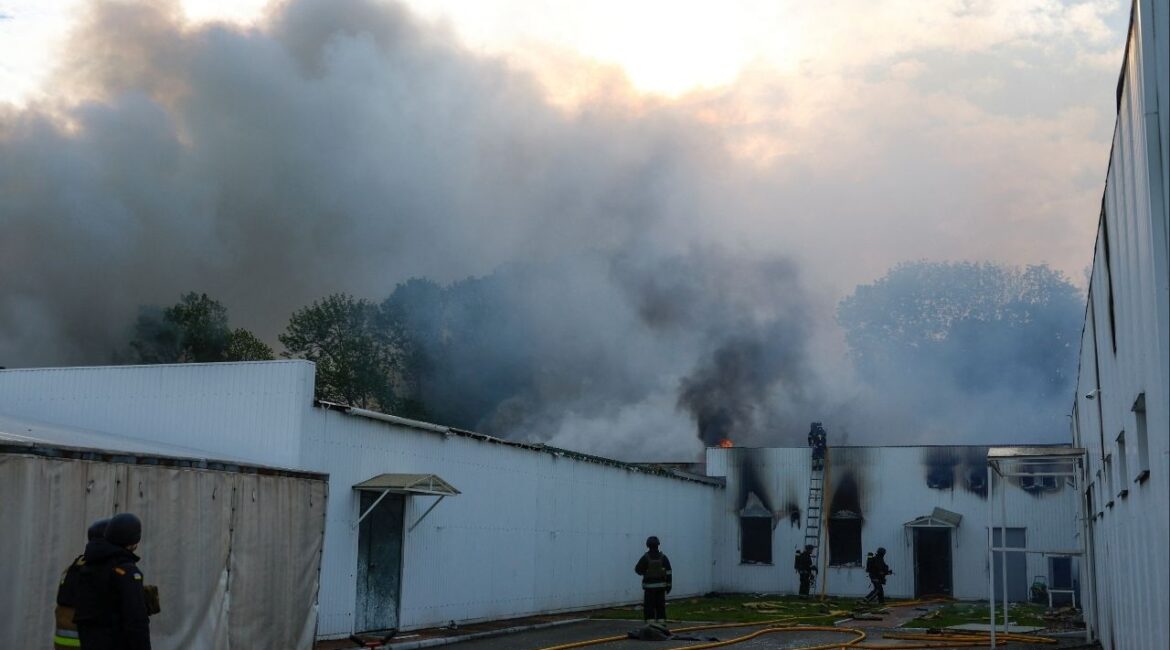 Firefighters work at the site of a private enterprise hit by a Russian drone strike, amid Russia's attack on Ukraine, outside of Kyiv, Ukraine May 18, 2025. REUTERS/Valentyn Ogirenko