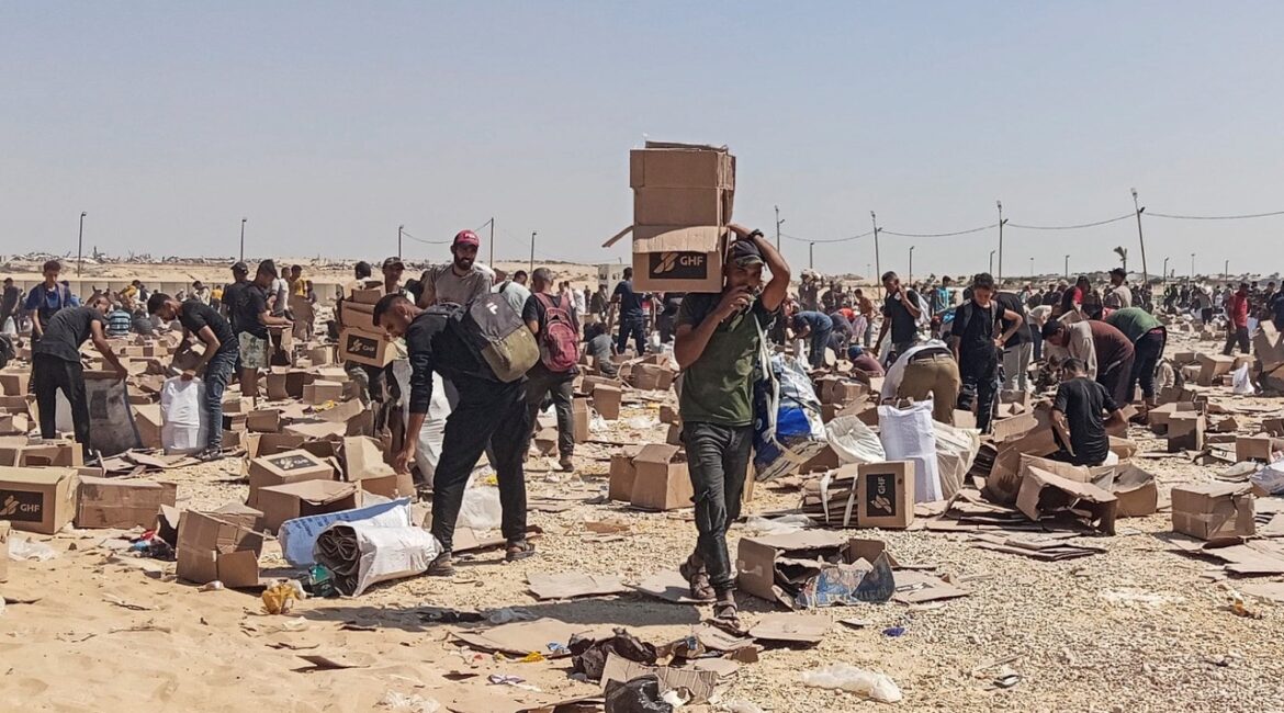 Palestinians gather to collect what remains of relief supplies from the distribution center of the U.S.-backed Gaza Humanitarian Foundation, in Rafah, in the southern Gaza Strip, June 5, 2025. (Reuters/Stringer)