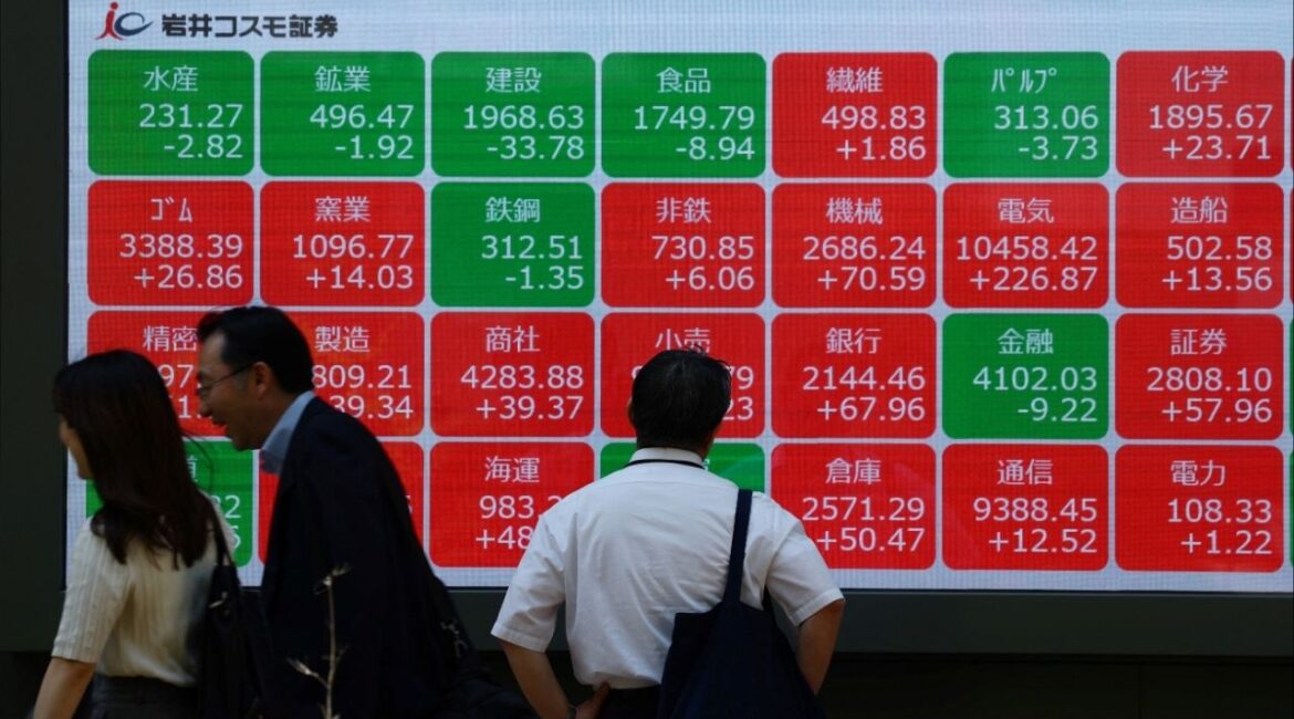 A man looks at an electronic board displaying sector performances related to Nikkei index outside a brokerage in Tokyo, Japan, May 13, 2025. (Reuters File)