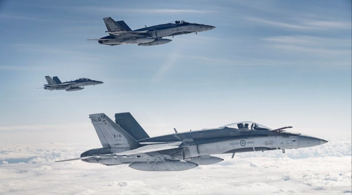 A pair of Royal Canadian Air Force (RCAF) CF-188 Hornets fly with a United States Navy EA-18G Growler during Exercise Maple Flag 51 over Alberta, Canada June 15, 2018. OS Erica Seymour/Canadian Forces/Handout via REUTERS/File Photo