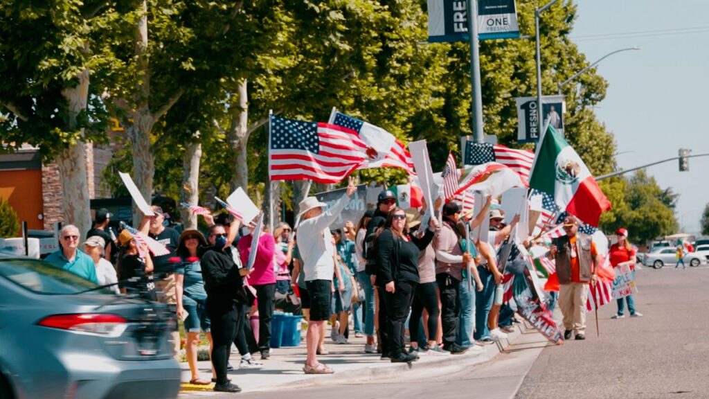 A photo of protesters waving flags and signs on Blackstone Avenue on Saturday, June 14, 2025. (GV Wire/Eric Martinez)