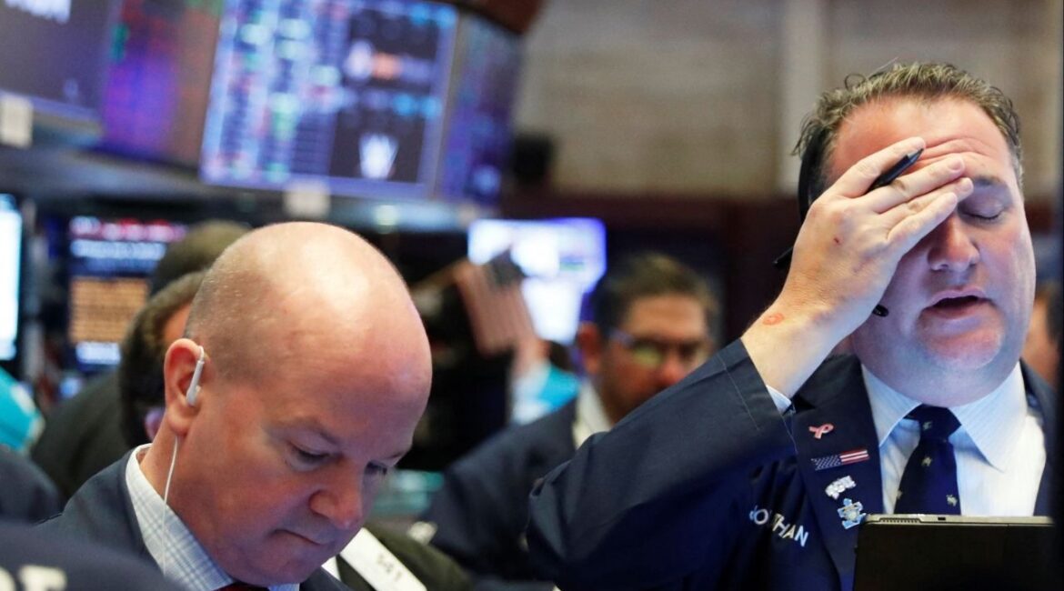 A trader reacts as he works on the floor of the New York Stock Exchange at the NYSE in New York, U.S., March 18, 2020. REUTERS/Lucas Jackson/ File Photo