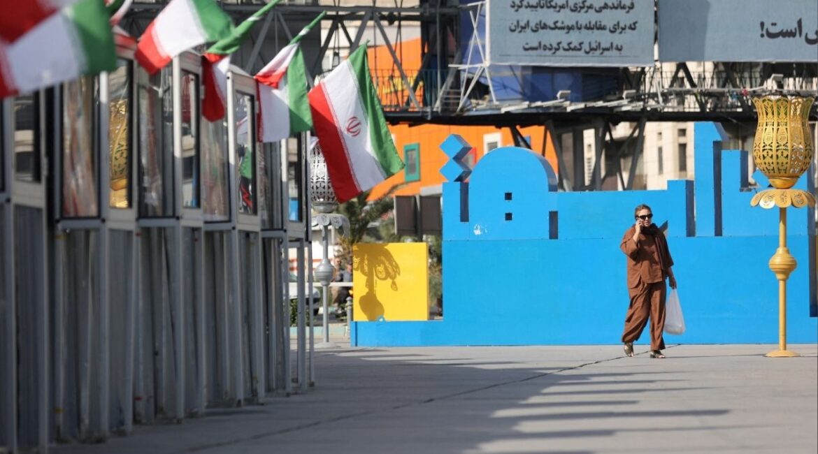 A woman walks on a street, amid the Iran-Israel conflict, in Tehran, Iran, June 23, 2025. Majid Asgaripour/WANA (West Asia News Agency) via REUTERS