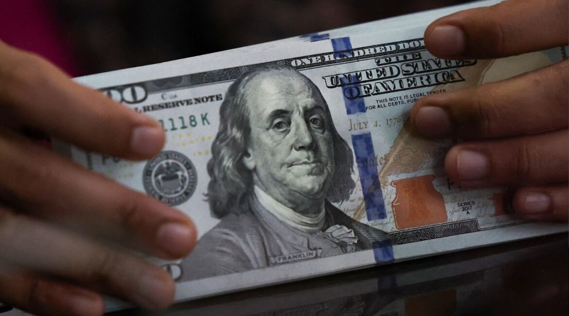An employee holds U.S. dollar bank notes at a money changer in Jakarta, Indonesia, April 9, 2025. (Reuters/Willy Kurniawan)