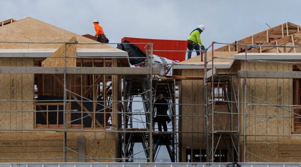 Construction workers use wood and lumber to build residential homes in Irvine, California, U.S., March 28, 2025. REUTERS/Mike Blake/File Photo