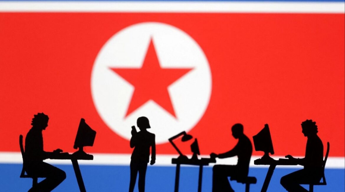Miniatures of people with computers are seen in front of North Korea flag in this illustration taken July 19, 2023. (Reuters File)