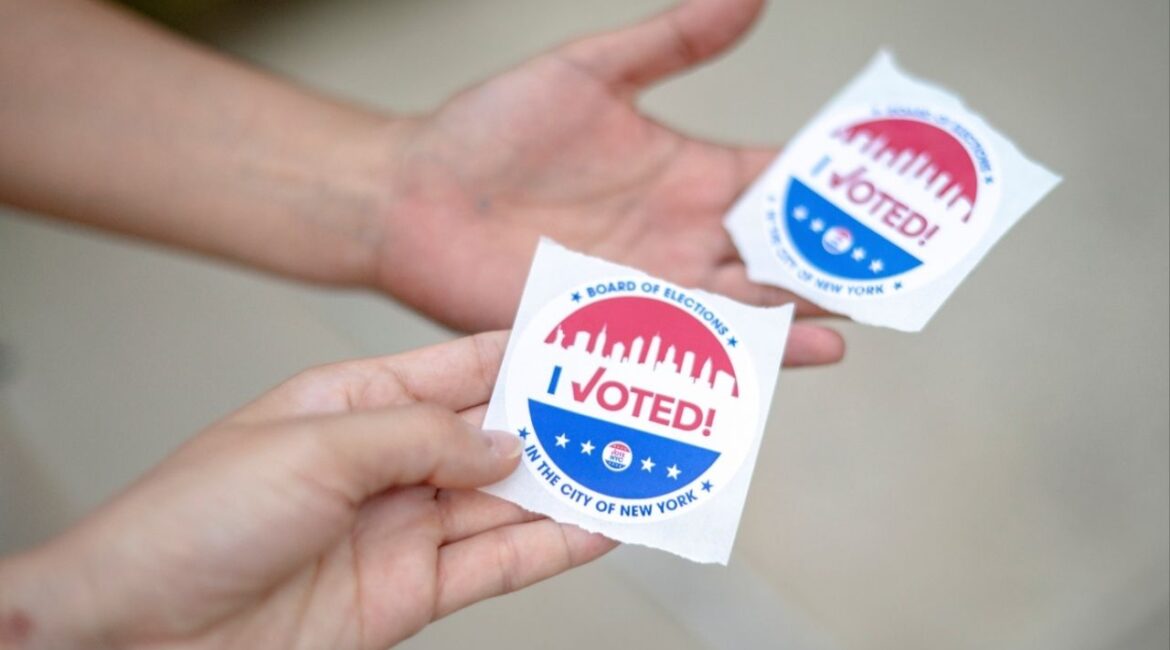 People hold “I Voted” stickers on Democratic primary day in New York, Tuesday, June 24, 2025. After months of campaigning, caustic debates and a deluge of attack ads, the consequential Democratic primary for mayor of New York City comes to a head on Tuesday as voters stream to the ballot box in blistering heat. (Hilary Swift/The New York Times)