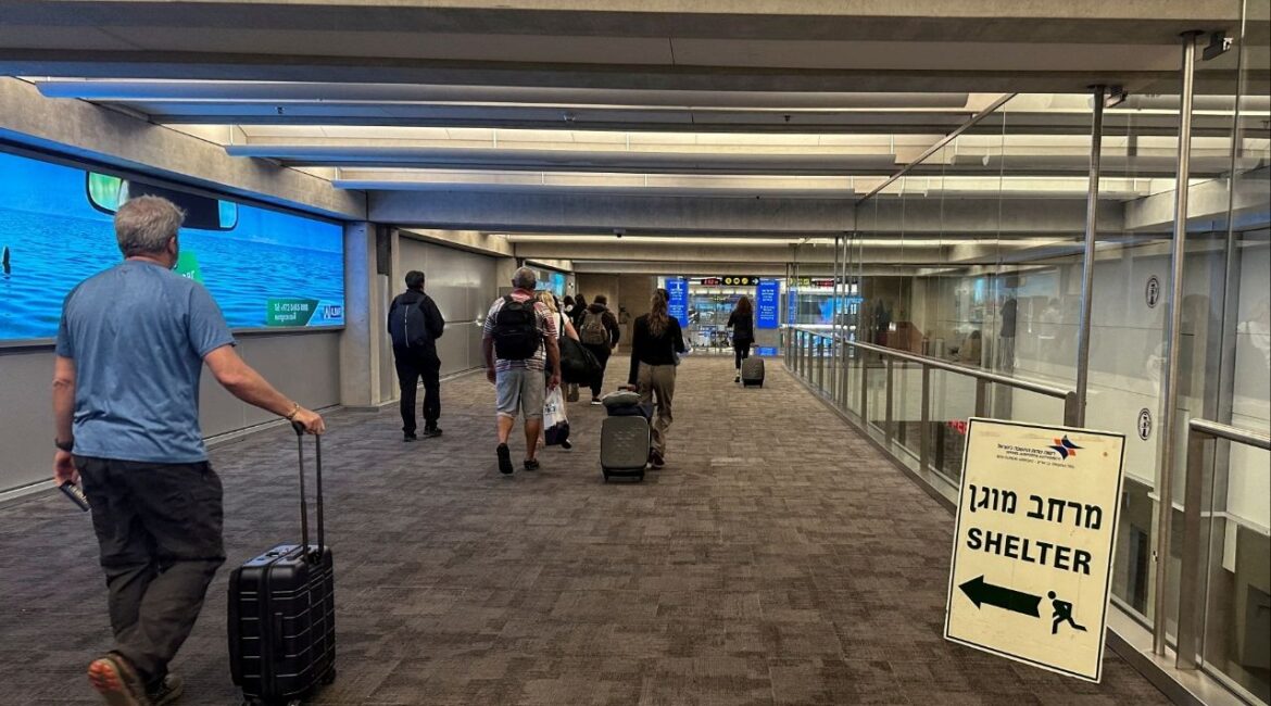 People walk next to a sign directing for Shelter after landing in Israel at the arrivals section of Ben Gurion International airport in Lod near Tel Aviv, Israel October 11, 2023. (Reuters File)