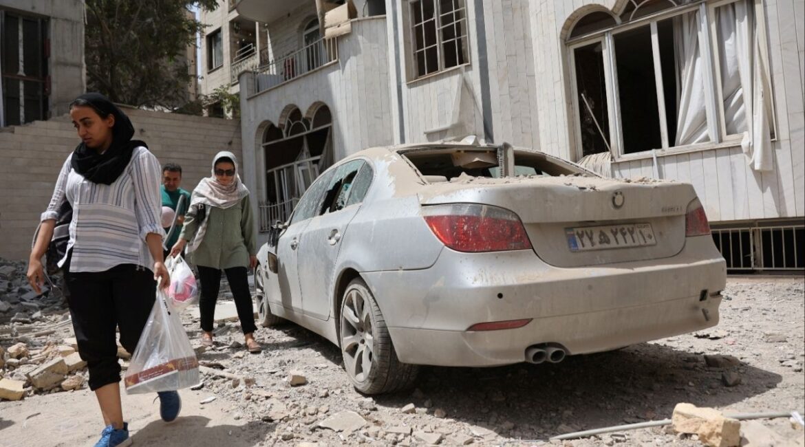 People walk outside a house following an Israeli strike on a building on Monday, after the ceasefire between Israel and Iran, in Tehran, Iran, June 26, 2025. Majid Asgaripour/WANA (West Asia News Agency) via REUTERS ATTENTION EDITORS - THIS PICTURE WAS PROVIDED BY A THIRD PARTY