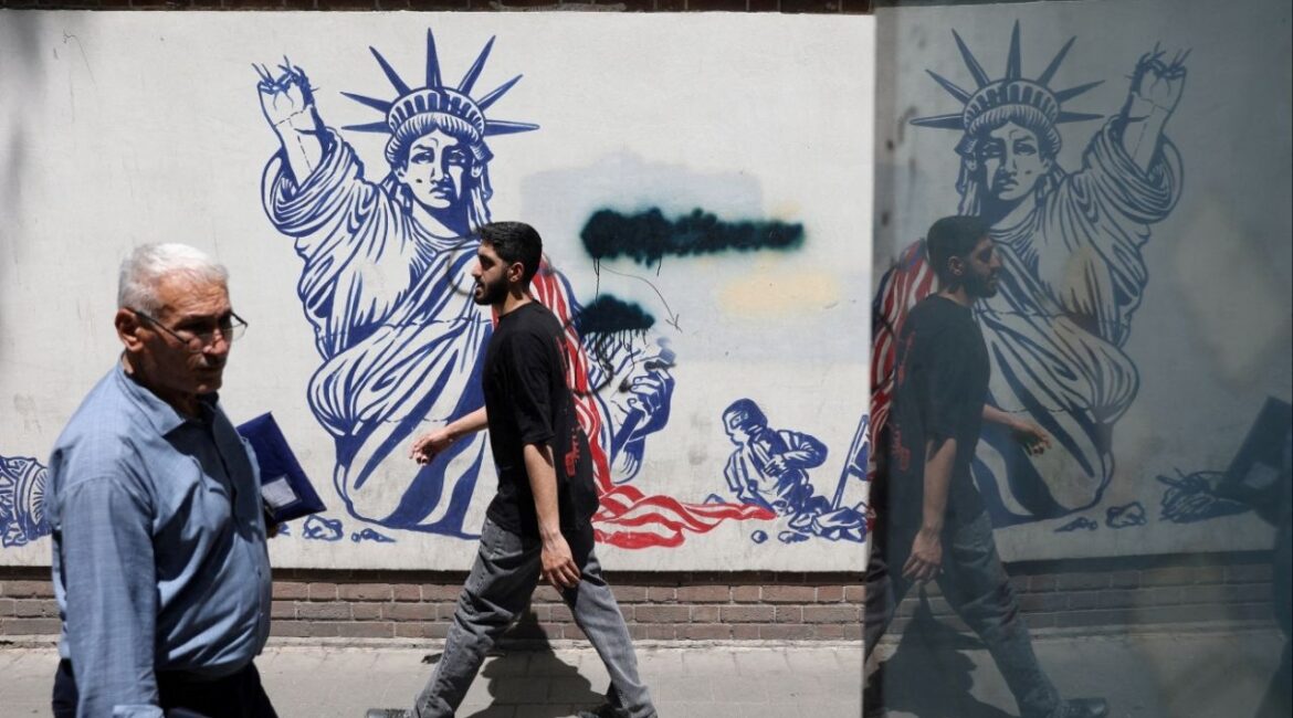 People walk past an anti-U.S. mural on a street in Tehran, Iran, May 11, 2025. Majid Asgaripour/WANA (West Asia News Agency) via REUTERS/File Photo